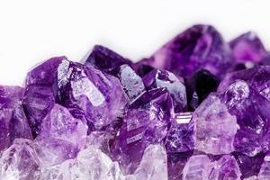 Macro mineral stone purple amethyst in crystals on a white background photo