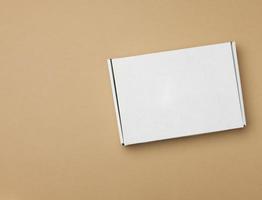white paper rectangular box on beige background, top view photo