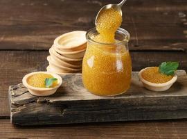 salted pike caviar in a glass jar on a wooden board photo