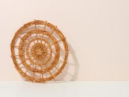 round wicker kitchen utensil rack on white table photo