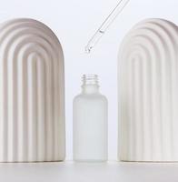 white glass bottle with pipette for cosmetics, oils and serum. Advertising and product promotion photo