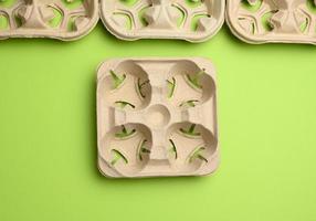 paper tray for drinks in takeaway cups on four cups  on a green background photo