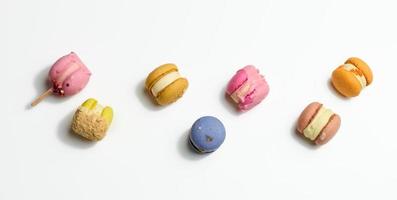 baked macarons with different flavors on a white background, top view photo