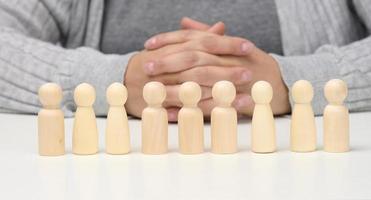 figurines of men on a white table. concept of searching for employees in the company, recruiting personnel, identifying talented and strong personaliti photo