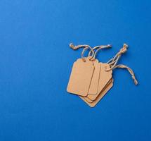 set of empty paper brown rectangular tags on a rope, price tags photo