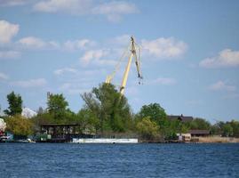 view of the river port with landing stage and cranes on a summer day. Kherson Ukraine photo