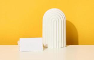 stack of white rectangular business cards on a yellow background, company branding, address. photo