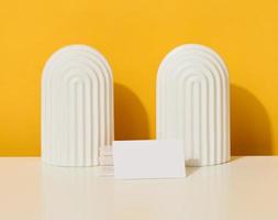 stack of white rectangular business cards on a yellow background, company branding, address. photo