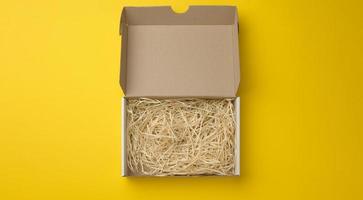 rectangular open corrugated paper box with sawdust inside photo