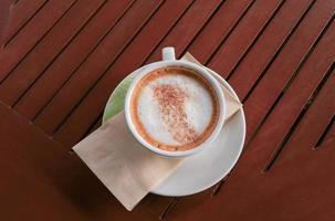 coffee cappuccino on the wood floor background photo