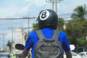 close up man driving the motorcycle with helmet  black  on road photo