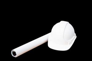 white safety helmet plastic and paper roll plan blueprint construction of engineering  isolated on black background and clipping path photo