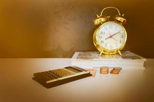 money, calculator and alarm clock old vintage gold over white and black background. with copy space add text retro style photo