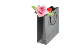 pink rose in black paper bag on white background  valentine day concept photo