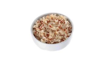 cooked brown rice in cup on white background photo