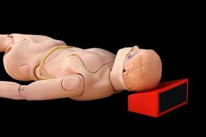 dummy for CPR medical  training to assist isolated on black background and clipping path photo