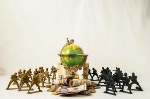 Plastic toy soldiers with globe and currency photo