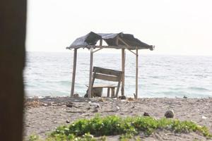 photo of a hut on the beach during the day