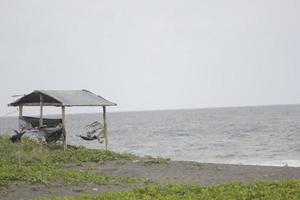 photo of a hut on the beach during the day