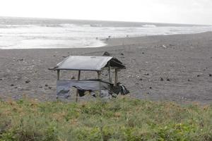 photo of a hut on the beach during the day