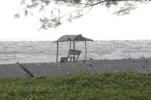 photo of a hut on the beach during the day