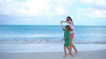 Beautiful mother and daughter on Caribbean beach. video