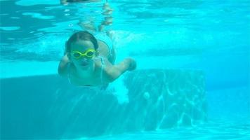 adorable niña en la piscina bajo el agua video