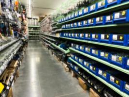 A blurry image of a hardware store with paints, varnish, brushes in a building materials store as a trading background. For the photo