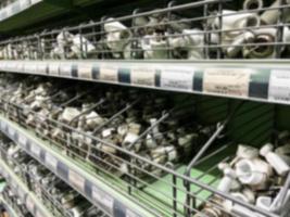 A blurry image of a hardware store with paints, varnish, brushes in a building materials store as a trading background. For the photo