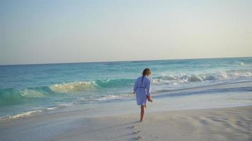 jolie petite fille marchant sur la plage pendant les vacances dans les Caraïbes video