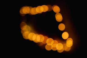 Take the light out of focus to create an oval, amber-colored bokeh in the darkness. photo