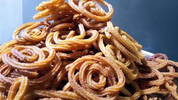 Indian Traditional Tea Time Snack Chakli, a deep fried snack, It is known as Chakali, Murukku, Muruku, Murkoo, Chakri. photo