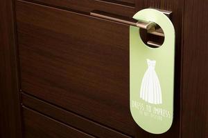 closed door with a sign on the handle Dress to impress Do not disturb photo