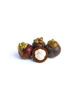 Mangosteen and cross section showing the thick purple skin and white flesh of the queen of friuts, on white background photo