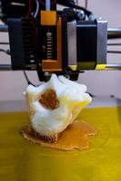 Modern 3D printer printing figure close-up macro 3d printer prints a vertebra photo