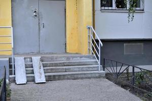 Clean entrance of a multi-storey building in the city. The iron door of a large house during the day. photo