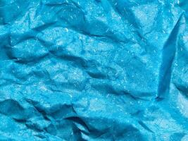 Texture of blue crumpled paper background for design photo