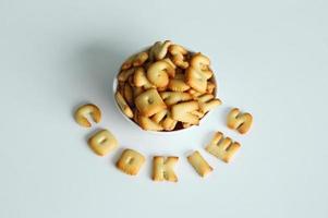 A bowl of cookies with inscription from the cookies on the white background. photo