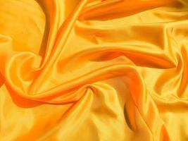 Yellow silk or satin texture background with copy space for design photo