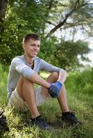 young man resting after cleaning the park photo