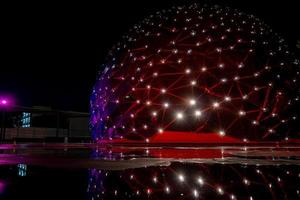 dome shaped building, with colored lights, reflection in water, parametric skin mexico photo