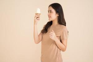 Happy young woman eating ice cream photo