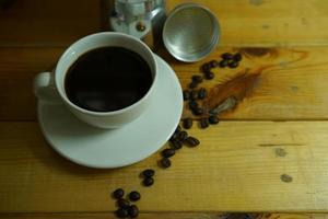 Hot black coffee in a white cup,coffee is a popular beverage all over the world. photo