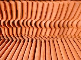 patterned abstract background, made of piles of stone building materials made of red clay photo