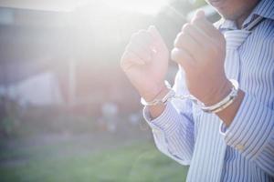 Businessman or politician with handcuffs. photo