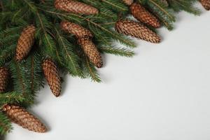 New Year's Eve background with fir branch and cones. Christmas and New Year holidays composition of pine tree branches. photo