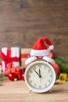 Merry Christmas with Vintage alarm clock and Xmas decoration on wooden table. party, holiday and boxing day concept photo