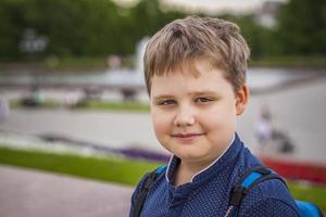 Portrait of a child, a boy against the backdrop of urban landscapes of skyscrapers and high-rise buildings in the open air. Children, Travel. Lifestyle in the city. Center, streets. photo