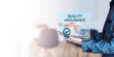 Quality Assurance Concept. Business people show high quality assurance mark, good service, premium, five stars, premium service assurance, excellence service, high quality, business excellence. photo