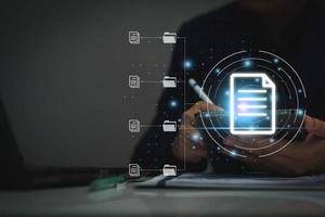 Document management system concept, business man using tablet search folder and document icon software, searching and managing files online document database, for efficient archiving and company data. photo
